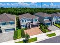 Beautiful two-story home featuring a well-manicured lawn and a brick-paved driveway at 7463 Marker Ave, Kissimmee, FL 34747