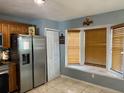 Spacious kitchen with stainless steel refrigerator and oven along with wooden cabinets and a bay window at 7834 Brockwood Cir # 2, Orlando, FL 32822