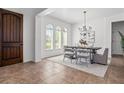 Bright dining room features a modern chandelier, arched windows, and stylish decor at 8531 Geddes Loop, Orlando, FL 32836