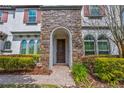 Inviting front entrance with stone accents, arched entryway, and manicured landscaping at 8531 Geddes Loop, Orlando, FL 32836