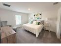 Cozy bedroom with plush carpet, decorative pillows, and abundant natural light at 945 Laurel View Way, Groveland, FL 34736