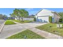 Single-Gathering home featuring an attached two-car garage, manicured lawn, and mature landscaping at 1318 Horizon Creek Ct, Orlando, FL 32828