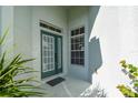 Charming front porch with a stylish green door and ample natural light, creating a welcoming entrance at 1318 Horizon Creek Ct, Orlando, FL 32828