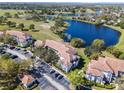 Aerial view of condos alongside a picturesque lake and golf course, offering beautiful community views at 13929 Fairway Island Dr # 825, Orlando, FL 32837