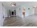 Spacious open-concept living area featuring modern flooring and plenty of natural light at 16 Flamevine Ln, Debary, FL 32713