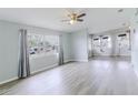 Bright living room showcasing new flooring and multiple windows offering ample natural light at 16 Flamevine Ln, Debary, FL 32713