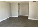 View of the well-lit living room featuring wood-look floors and neutral paint at 165 Springwood Circle # A, Longwood, FL 32750