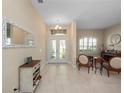 Bright foyer with tile flooring and decorative mirror offers a warm welcome at 1659 Cherry Blossom Ter, Lake Mary, FL 32746