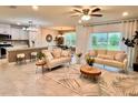 Open-concept living room featuring neutral furnishings, stylish decor, and ample natural light at 17394 Million Lakes Ct, Clermont, FL 34714