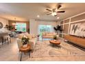 Open-concept living room featuring neutral furnishings, stylish decor, and ample natural light at 17394 Million Lakes Ct, Clermont, FL 34714