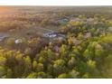 Aerial view of a luxurious estate nestled among lush green trees and landscaping, offering privacy and tranquility at 1814 Old Stable Pt, Chuluota, FL 32766