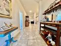 Bright hallway with tile flooring, decorative furnishings, and an open view to the living spaces at 2107 Cartgate Ln, Winter Haven, FL 33884