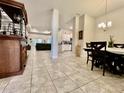 Open-concept living and dining area featuring tile flooring, columns, and contemporary lighting at 2107 Cartgate Ln, Winter Haven, FL 33884