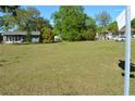 Expansive vacant lot with green grass ready for development with neighboring houses shown at 2525 S Sanford Avenue Ave, Sanford, FL 32773