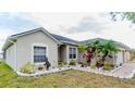 Beautiful single-story home featuring vibrant landscaping and a well-maintained lawn at 2904 Sweetspire Cir, Kissimmee, FL 34746