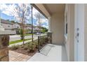 Cozy front porch with stone accents and iron railings provides a welcoming entrance at 4409 Summer Flowers Pl, Kissimmee, FL 34746