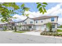 Street view of townhomes with manicured lawns and attached garages at 4409 Summer Flowers Pl, Kissimmee, FL 34746