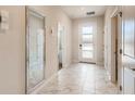 Bright foyer featuring marble floors, a large mirror, recessed lighting, and doors leading to other rooms at 2859 Bookmark Dr, Kissimmee, FL 34746