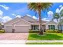 Beautiful single-story home with a three-car garage, lush lawn, tasteful landscaping, and mature palm trees at 4770 Cypress Forest Ln, St Cloud, FL 34772