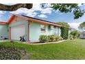 Side view of a one-story home showing the attached garage, lawn, and minimal landscaping at 4792 Indian Gap Dr, Orlando, FL 32812