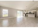 Open-concept living room with tile flooring, bright natural light and modern light fixtures at 514 Bristol Cir, Kissimmee, FL 34758