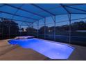 Inviting in-ground pool with integrated spa and screened enclosure at 6155 Hedgesparrows Ln, Sanford, FL 32771