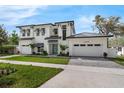 Inviting home featuring a manicured lawn, stylish front door, and a spacious three-car garage at 640 Old Horatio Ave, Maitland, FL 32751