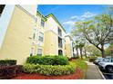 Exterior view of the property showing landscaping and sidewalk at 8819 Dunes Ct # 208, Kissimmee, FL 34747