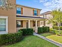 Charming home features a well-maintained front yard with lush green grass and mature landscaping at 9024 Savannah Magnolia Ln, Orlando, FL 32832