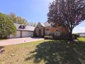 Stunning house with three car garage, stone details and archway entrance at 9137 Southern Breeze Dr, Orlando, FL 32836