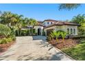 Charming home featuring a tile roof, a concrete driveway, and well-maintained landscaping at 9783 Covent Garden Dr, Orlando, FL 32827