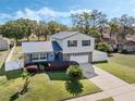 Beautiful exterior view with a well-manicured lawn and metal roof at 1189 Lazy Hollow Pl, Winter Park, FL 32792