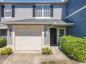 Charming townhome featuring a one-car garage and well-maintained landscaping at 12723 Somerset Oaks St, Orlando, FL 32828