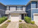 Charming townhome featuring a one-car garage and well-maintained landscaping at 12723 Somerset Oaks St, Orlando, FL 32828