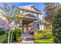 Charming two-story townhome with a brick walkway and manicured front lawn and garden at 14433 Pleach St, Winter Garden, FL 34787