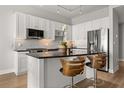 Bright kitchen with white cabinets, stainless steel appliances, a breakfast bar, and modern finishes at 150 E Robinson St # 2608, Orlando, FL 32801