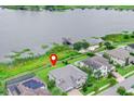 Aerial view of the property showcasing lakefront location with dock, lush greenery, and proximity to the water at 16689 Broadwater Ave, Winter Garden, FL 34787