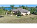 Well-maintained home showcasing lush landscaping and partial water views at 16752 Caravaggio Loop, Montverde, FL 34756