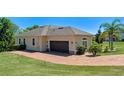 A spacious garage with a brick-paved driveway leading up to the home at 16752 Caravaggio Loop, Montverde, FL 34756