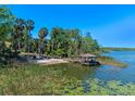 Lakeside area with dock, boat house, and beach at 16752 Caravaggio Loop, Montverde, FL 34756