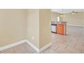 Open-concept kitchen featuring stainless steel appliances, tile floors, and a breakfast bar at 2311 Whitley Ln, Winter Haven, FL 33881