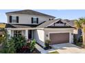 Charming two-story home featuring an attached two-car garage with beautiful landscaping at 3029 High Pointe St, Clermont, FL 34711
