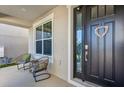 Inviting front porch featuring comfortable seating and a welcoming front door at 3029 High Pointe St, Clermont, FL 34711