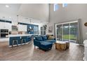 Open-concept living room with high ceilings and views of the kitchen and backyard at 3029 High Pointe St, Clermont, FL 34711