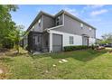 Backyard view showcases the screened patio and the home's exterior at 3173 Riverboat Way, Oviedo, FL 32765