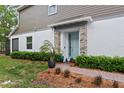 Inviting front entrance with a light blue door, stone pillars, and well-manicured green hedges at 3173 Riverboat Way, Oviedo, FL 32765