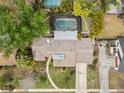 Aerial view of a home with a screened-in pool, a spacious yard and mature trees at 320 Isabella Dr, Longwood, FL 32750