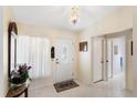 Bright foyer with tile flooring, decorative chandelier, and a view into the home at 3748 Innisbrook Dr, Lakeland, FL 33810