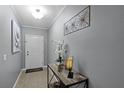View of the entryway showing the front door and console table with flowers and decor at 434 Ironside Trail Dr, Groveland, FL 34736