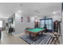 Spacious game room featuring a pool table, media, and comfortable seating area at 434 Ironside Trail Dr, Groveland, FL 34736